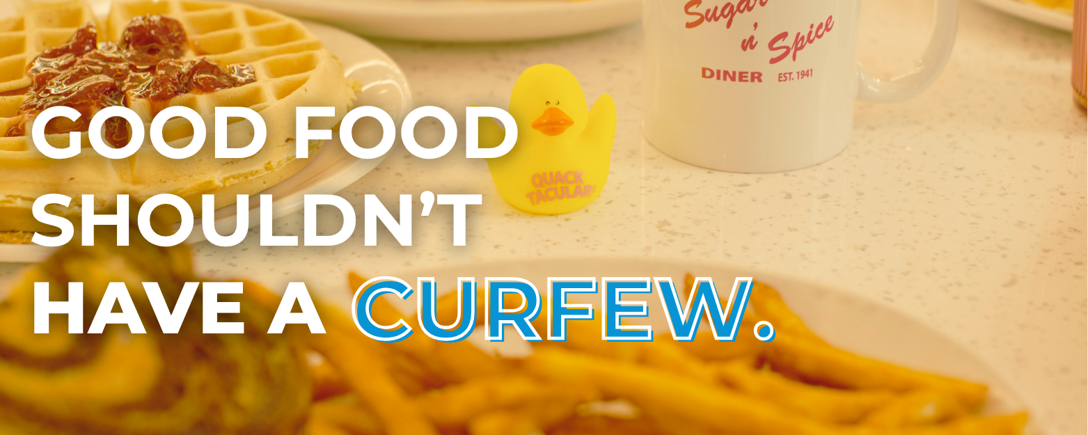 Image of a table full of food with the words "Good Food Shouldn't Have a Curfew"
